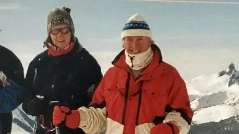 Family handout Lesley and her father Paul, who are both wrapped up and wearing ski clothes, are pictured on the ski slopes in this picture taken in years gone by. 