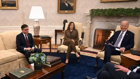 Getty Images Kamala Harris with Speaker Mike Johnson and Joe Biden