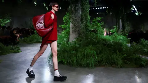 Reuters A model presents creations by Gucci at a fashion show in the Turbine Hall at Tate Modern, in London, Britain May 13, 2024. 