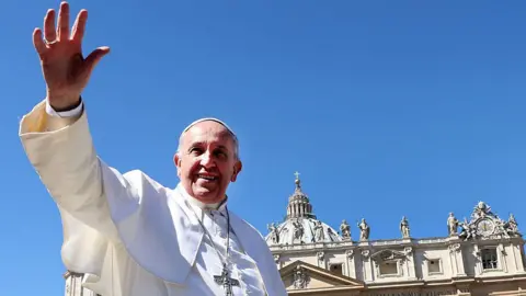 Getty Images Pope Francis, wearing white, waves as he leaves St. Peter's Square at the the end of Palm Sunday Mass on March 29, 2015 in Vatican City, Vatican.