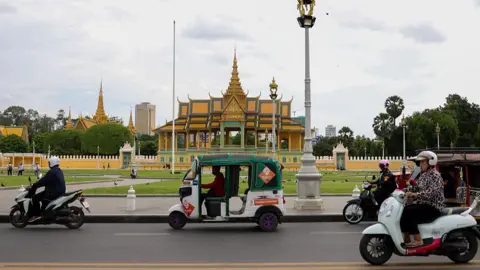 Getty Images Vehicles drive past Royal Palace of Cambodia in Phnom Penh, Cambodia on 25 July 2025.