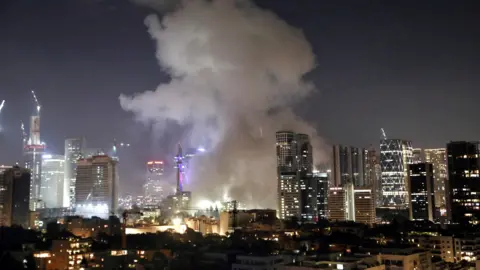Reuters Smoke rises from central Tel Aviv following an Iranian ballistic missile attack on Israel (14 June 2025)