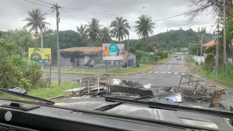 A road barricaded by rioters in Noumea on Wednesday