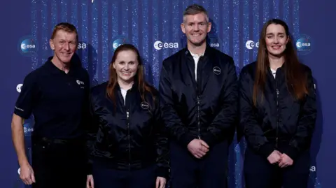 Getty Images British astronaut Major Tim Peake, ESA Astronaut Class of 2022 Meganne Christian, ESA's British astronaut John McFall and ESA Astronaut Class of 2022 Irish Rosemary Coogan pose during a ceremony to unveil the European Space Agency five new class of career astronauts in Paris