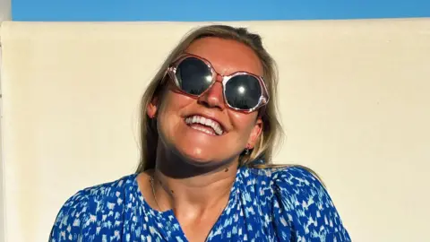 Supplied A woman in shades smiling in the sunshine