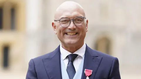 PA Media Gregg Wallace, a bald man wearing glasses, a white shirt, navy tie, light blue waistcoat and navy suit.