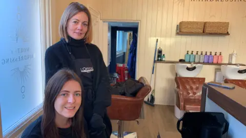 Emma and Jade, client and hairdresser, pictured in Worthy Hairdressing salon in Conwy 