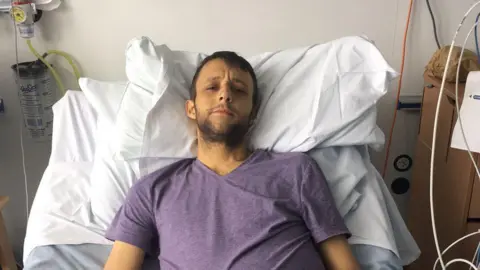 Supplied Mr Brailsford, with jaundice, sat in a hospital bed