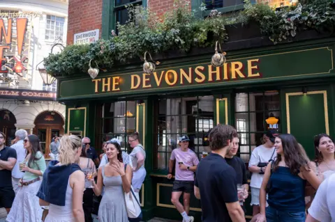 Getty Images People standing and drinking outside The Devonshire pub