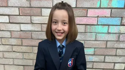 FAMILY PHOTO The 11-year-old, pictured on her first day, has found going back stressful