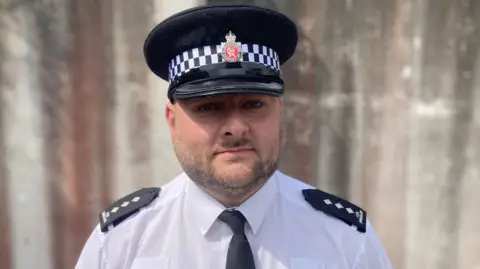 Head and shoulders of Chief Inspector Ash Shingler from Gloucestershire Police in uniform