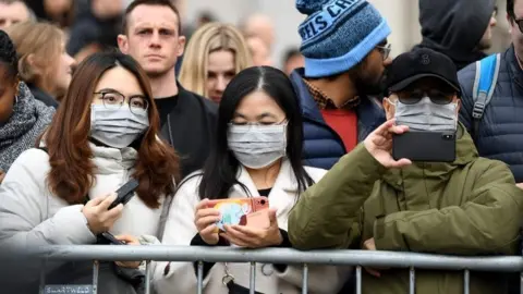 AFP People wearing masks at London celebrations