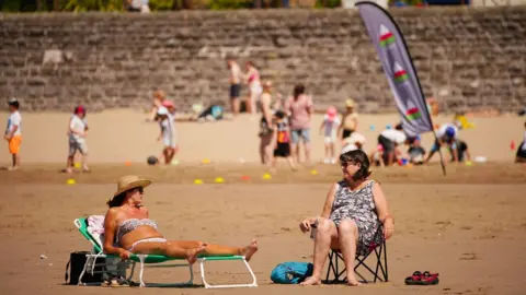 PA Media People are flocking to the beaches around the UK, like here at Barry Island in Wales