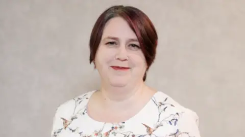 R Hobbs a woman with short dark hair