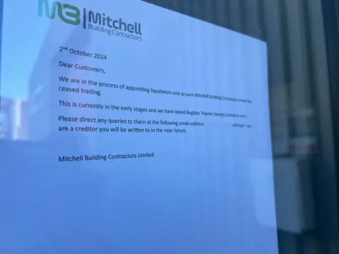 The letter pinned to the building firm's window dated 2 October. It informs customers that liquidators are being appointed and it has ceased trading, advising them to email Begbies Taylor with queries.