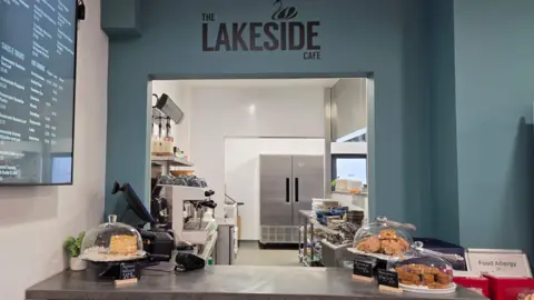 Rotherham Council A serving hatch inside a cafe with plates of cakes and scones, a coffee machine and newly painted walls