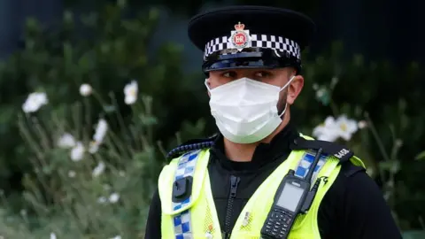 Reuters GMP officer in mask