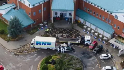 Reuters Aerial shot of vehicle removing a taxi that exploded outside a hospital