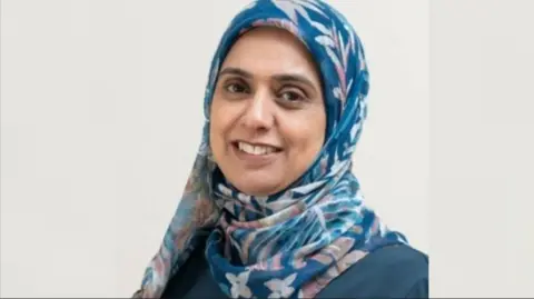 Cranfield Trust Shot of Salma Ravat. She is wearing a blue headscarf.