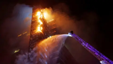 Reuters The corporate building of the multinational energy company ENEL, is seen on fire during a protest against the increase in the subway ticket prices in Santiago