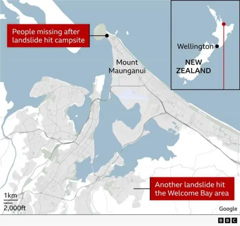 Map showing the Mount Maunganui area in New Zealand’s Bay of Plenty. A marker indicates a campsite where people are missing after a landslide. Another labelled area shows a second landslide in the Welcome Bay area to the south. Roads, waterways and coastal features are visible, with a scale bar showing distances. An inset map shows New Zealand with Wellington marked for location context.