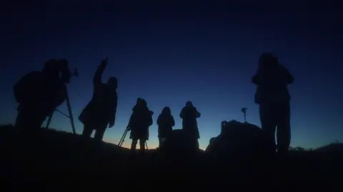 BBC/Tony Joliffe Astronomers look up at the sky at the dark sky reserve at Banau Brecheniog in south Wales.