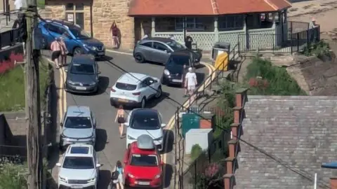 Helen Whitehead Cars parked on double yellow lines on a ramp near that leads to Cullercoats lifeboat station 