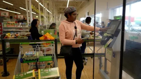 Safina paying at Asda