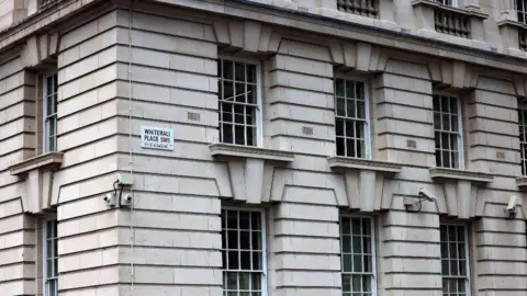 Civil Service offices in Whitehall in London, Britain. They are housed in a large white-ish grey building.