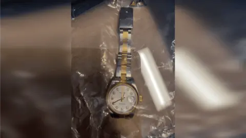 Met Police A Rolex watch on a plastic bag.