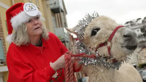 PA Media Ann Widdecombe with a donkey