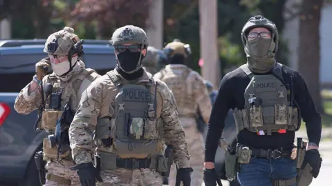 Getty Images Federal law enforcement officers wearing masks in Illinois in October 2025. 