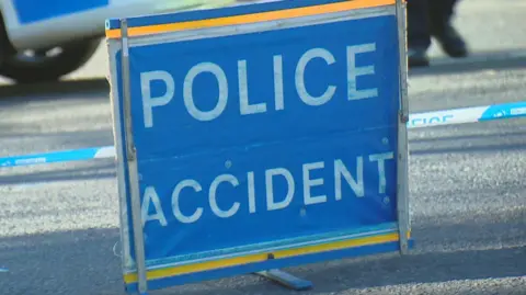 A police accident sign, bold white letters on a blue sign.