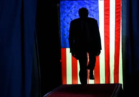 Jeff Swensen/Getty Images Former U.S. President Donald Trump enters Erie Insurance Arena for a political rally while campaigning for the GOP nomination in the 2024 election on July 29, 2023 in Erie, Pennsylvania.