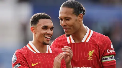 Liverpool's Trent Alexander-Arnold and Virgil van Dijk share a joke after last month's game against Leicester