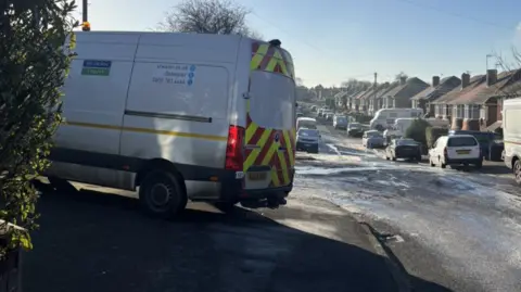 A Severn Trent van parked on an icy town street