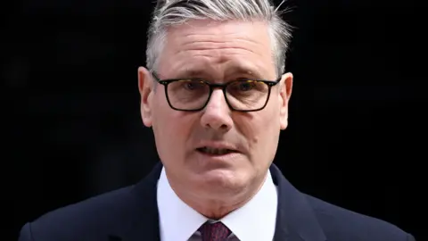 Reuters Prime Minister Sir Keir Starmer announces his resignation outside 10 Downing Street in London.