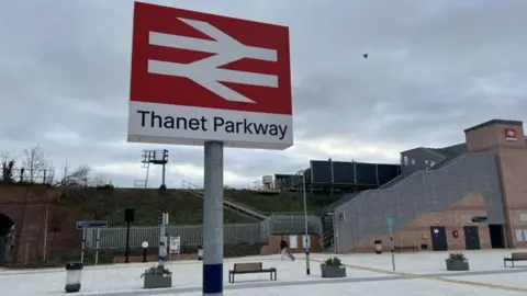 The sign for Thanet Parkway, with the station in the background