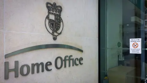 The Home Office logo on the exterior of a Home Office building