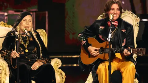 Reuters Joni Mitchell performs with Brandi Carlile during the 66th Annual Grammy Awards