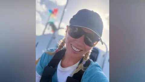Team Do The Thing A selfie of a woman wearing a cap and large sunglasses. She is smiling and is on a boat
