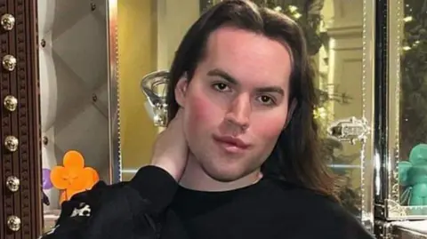 Jack Watkin is posing while holding a luxury handbag in another Instagram image.