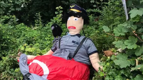 BBC A scarecrow depicting a pilot in an airplane 