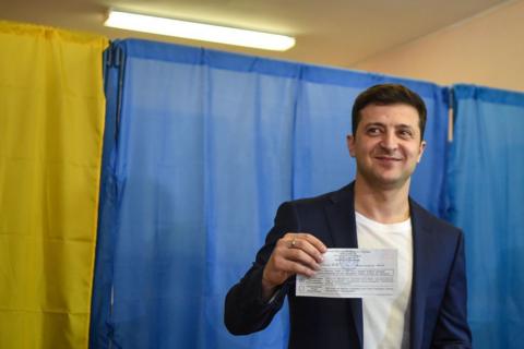 Mr Zelensky shows his ballot to the media at a polling station during the second round of Ukraine's presidential election in Kyiv in April 2019