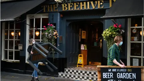 Getty Images Pub staff pack away outdoor tables in Scotland