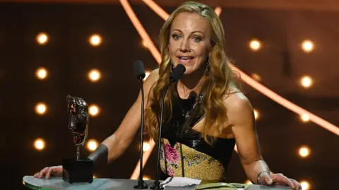 Getty Images Scottish screenwriter and producer Lesley Paterson accepting best adapted screen play for All Quiet on the Western Front