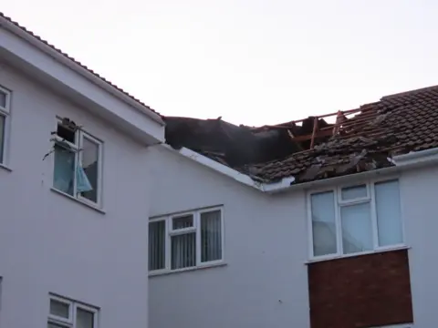 A view of the roof of the building showing part of it missing
