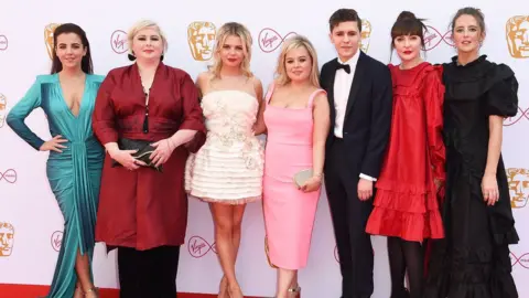 Getty Images Nicola (middle) with the rest of the Derry Girls cast at the Baftas