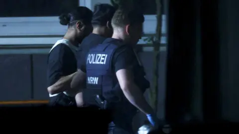 Reuters German police detain a man in Solingen late on Saturday. Photo: August 24, 2024