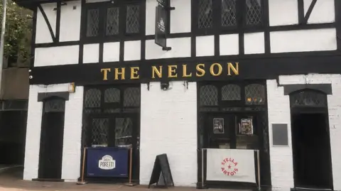 Abbie Nelson A pub seen from the outside on the street. The name reads: The Nelson.